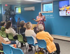 A photo of a lecture being given at the library.